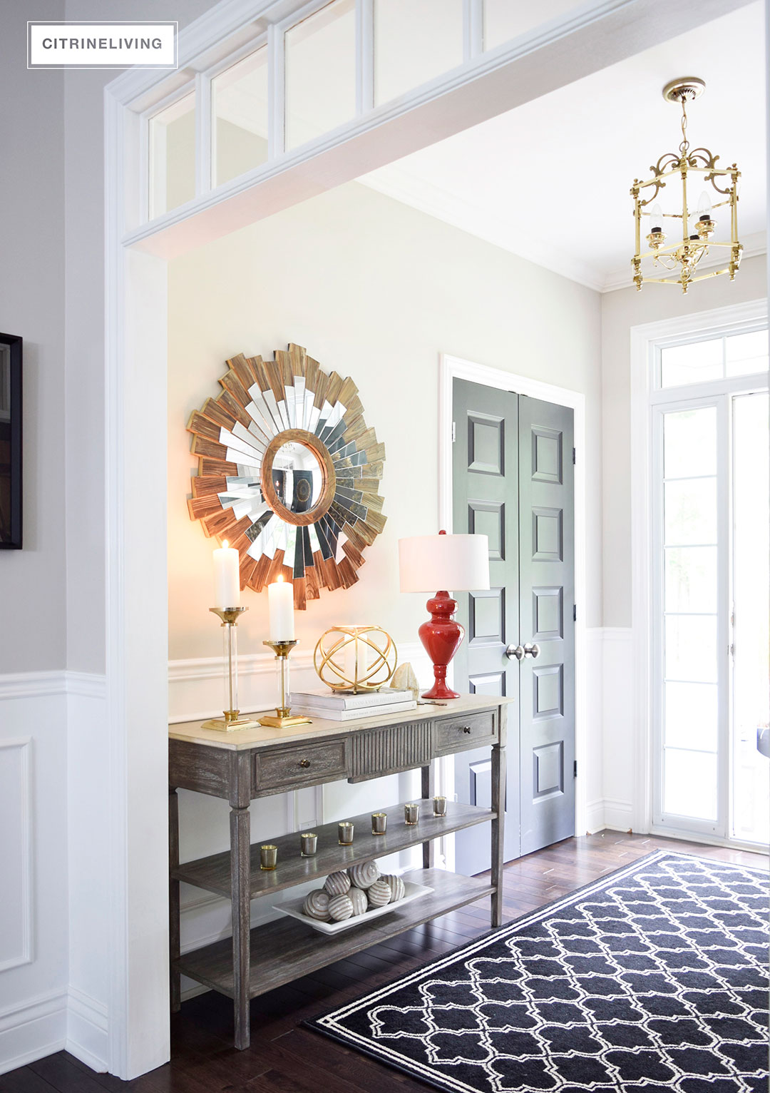 Fall decorated entryway with neutral and metallic decor and a punch of color for visual interest