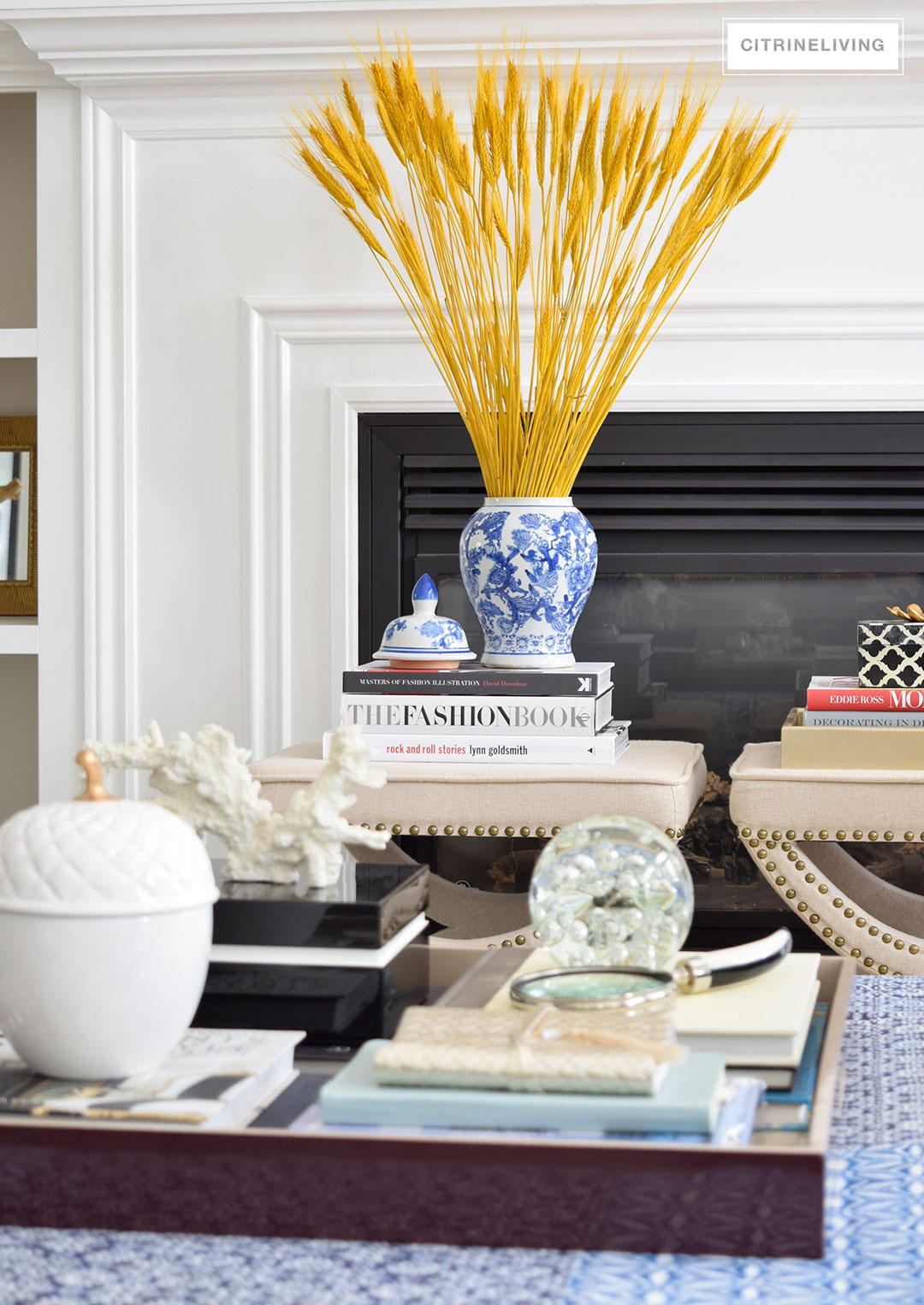 Fall decorated living room featuring rich blue velvet and gold, and blue and white accents 