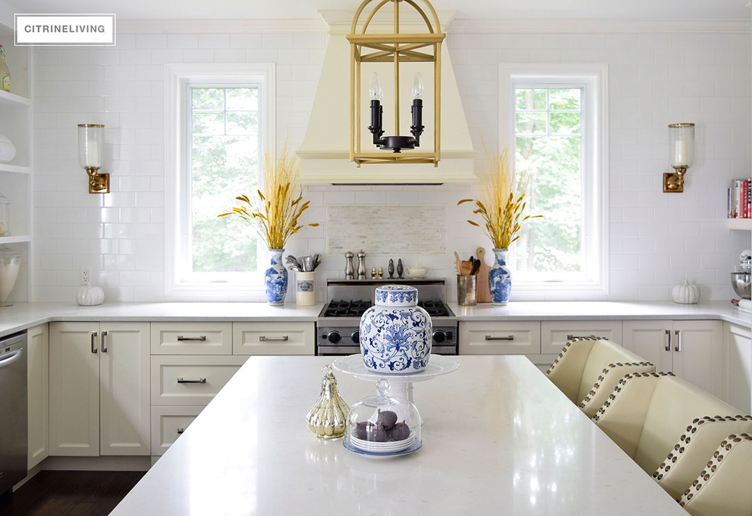 Fall decorated kitchen with blue and white ginger jars, rich gold accents and figs as a decorative element