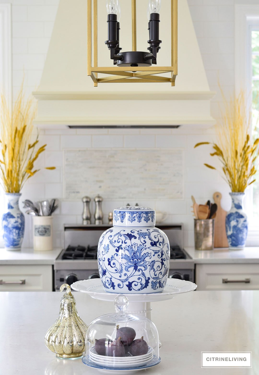 Fall decorated kitchen with blue and white ginger jars, rich gold accents and figs as a decorative element