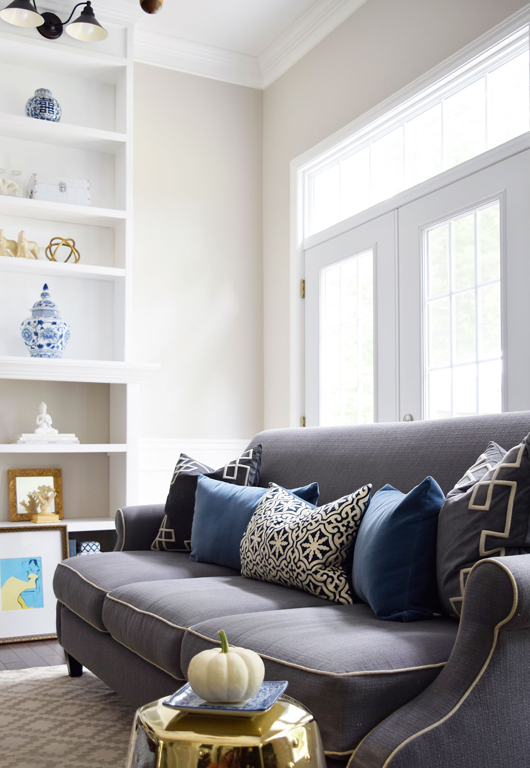 Fall decorated living room featuring rich blue velvet and gold, and blue and white accents 