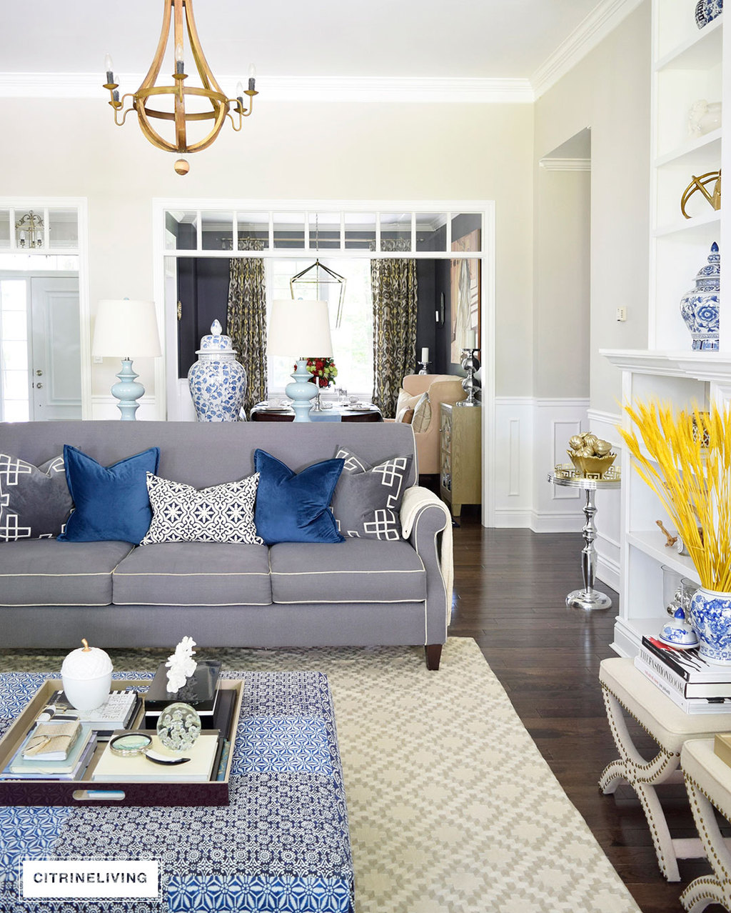 Fall decorated living room featuring rich blue velvet and gold, and blue and white accents 