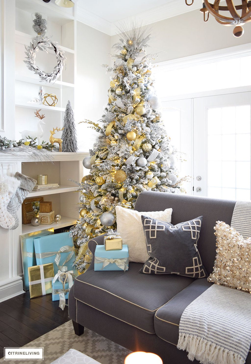 Christmas Home Tour - Stunning flocked Christmas tree with beautiful metallics and icy blue create a chic Holiday theme