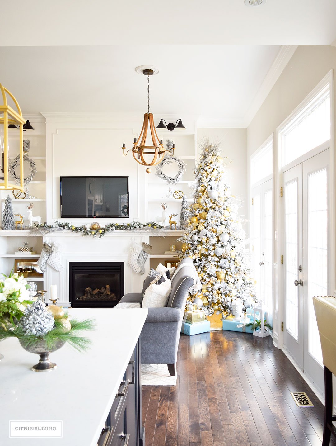 Christmas Home Tour - Stunning flocked Christmas tree with mixed metallics and icy blues accents create a perfectly chic Holiday theme