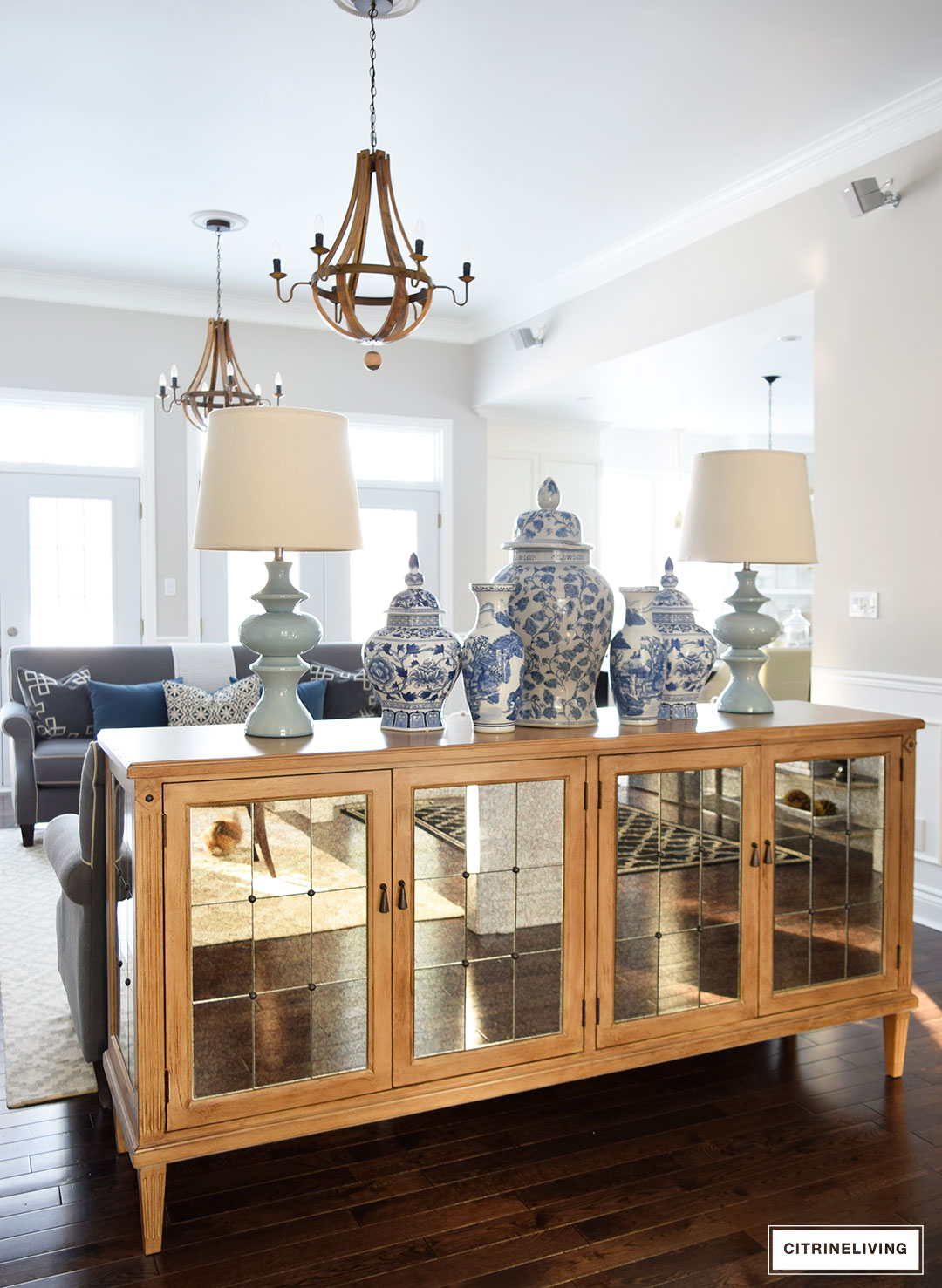 Mirrored buffet styled with blue and white ginger jars and vases grouped together in different sizes.