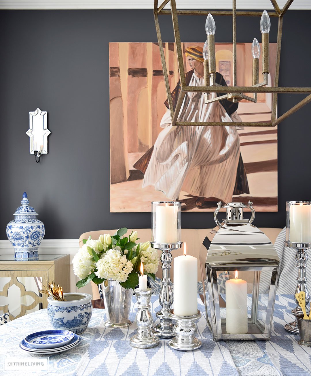 Fresh flowers and layers of blue and white pattern with silver candleholders and gold flatware is perfect for a Spring table.