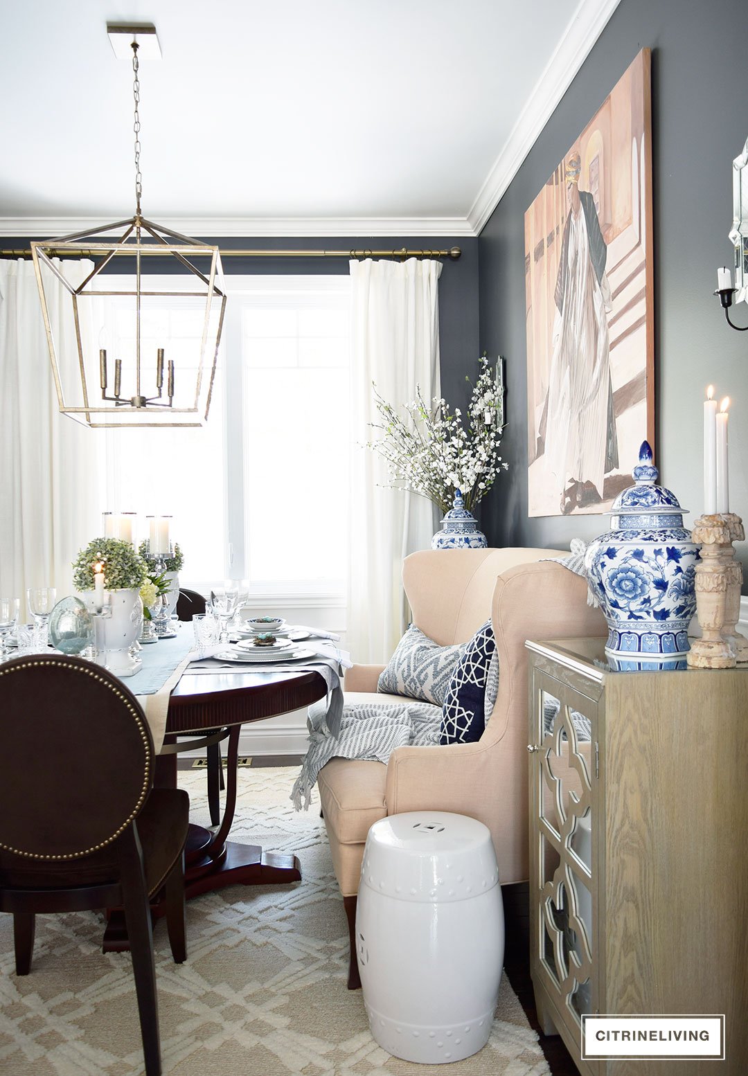 Small space dining room with settee and garden stools for extra seating. Easter and Spring tablescape with mercury glass accents.