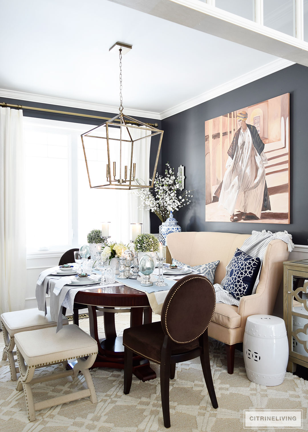 Elegant dining room with black walls and blue and white chinoiserie accents. A simple Easter or Spring tablescape with metallic accents adds sophistication.