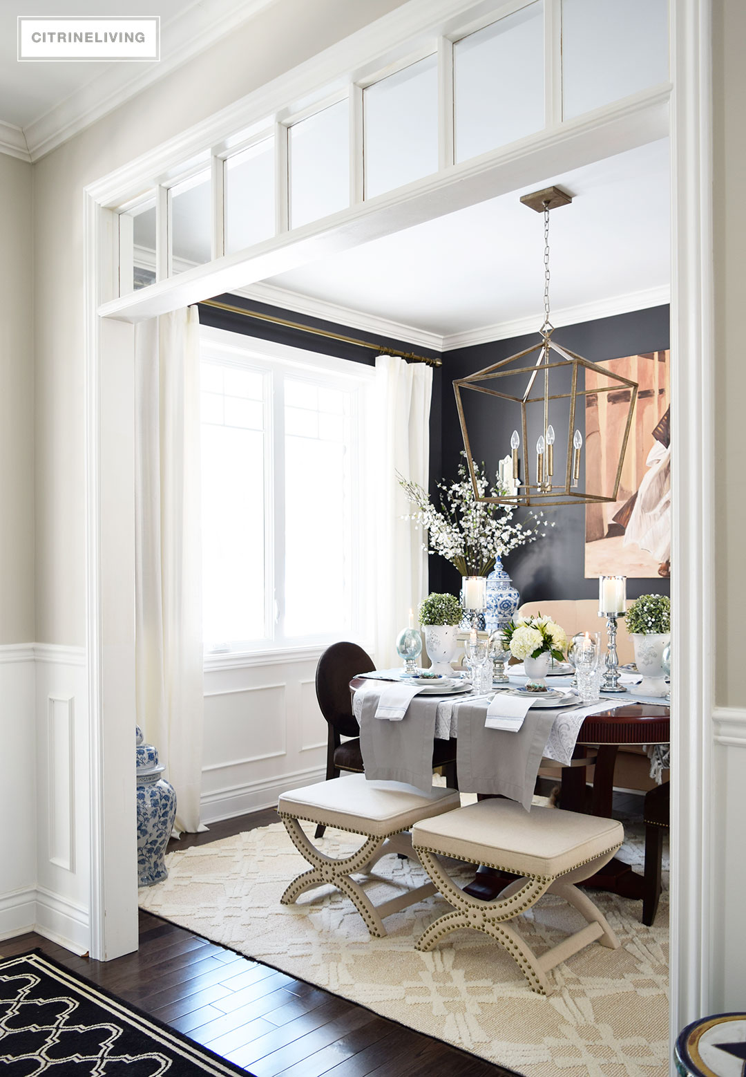 Dining room with elegant black wall color, Cracked Pepper Behr Paint, white wainscotting and transoms