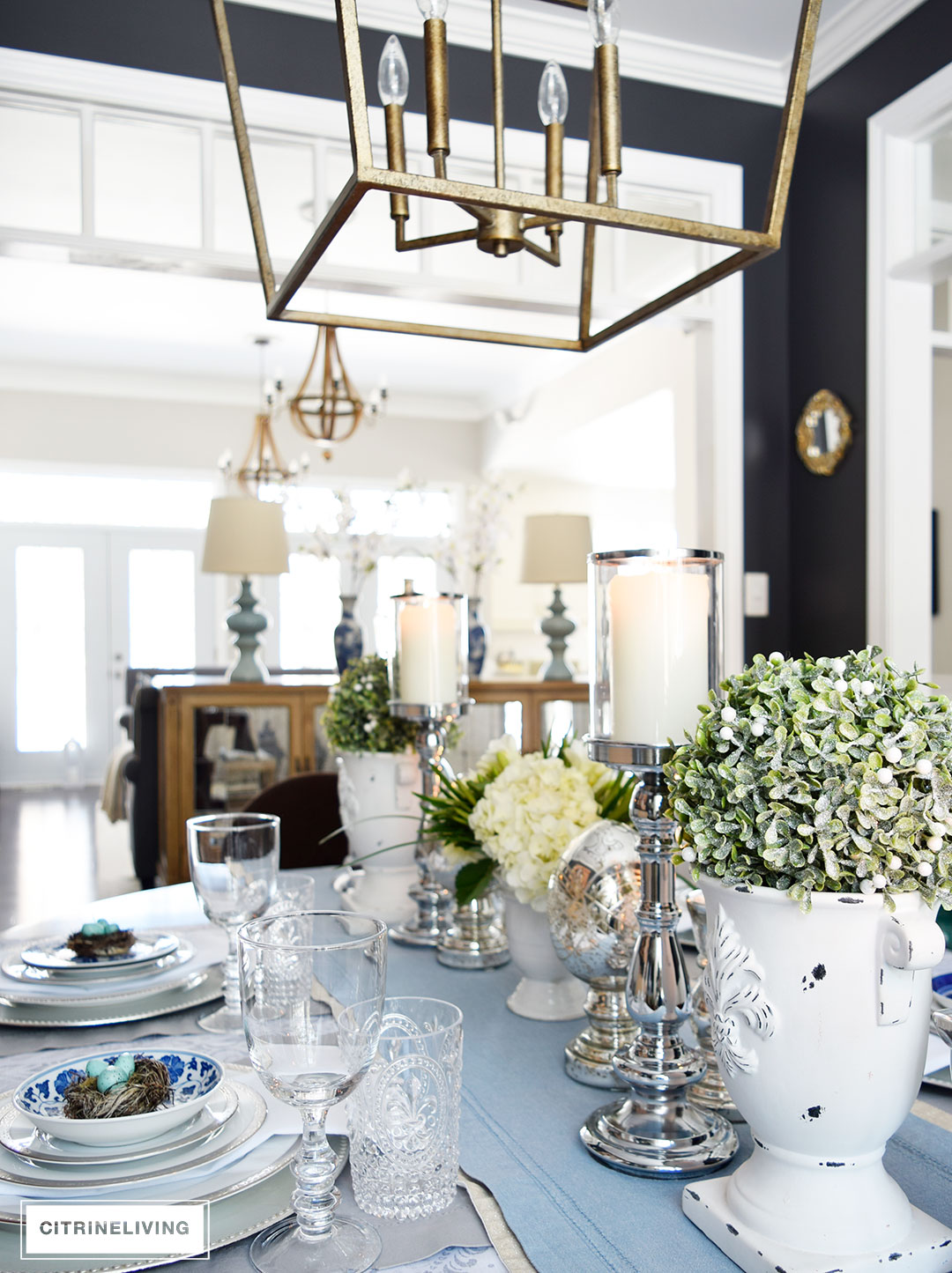 An elegant and simple Easter tablescape with topiaries and hydrangeas.