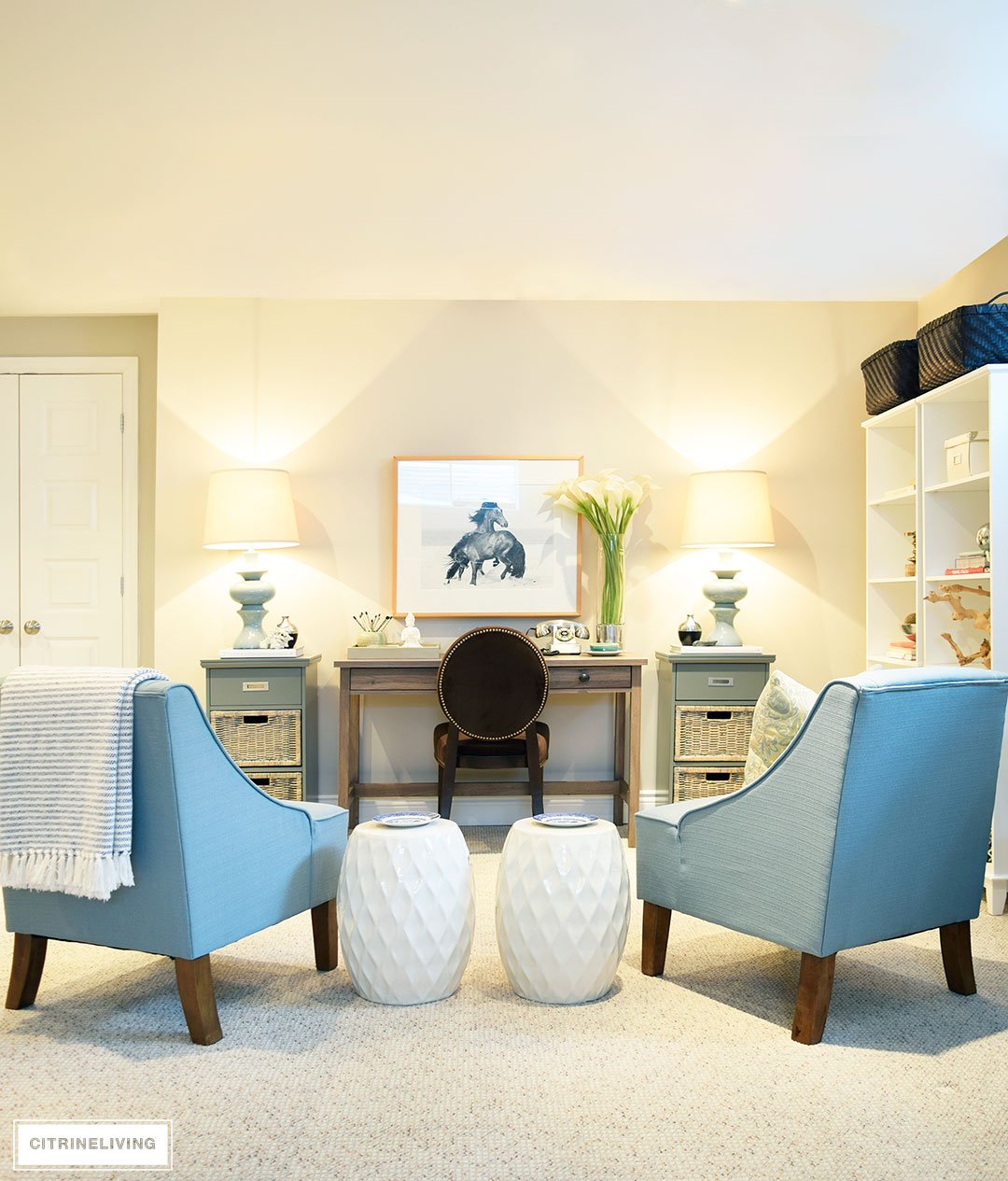 Style tip: A pair of garden stools is always practical and beautiful in any space! This basement office space is chic and sophisticated!