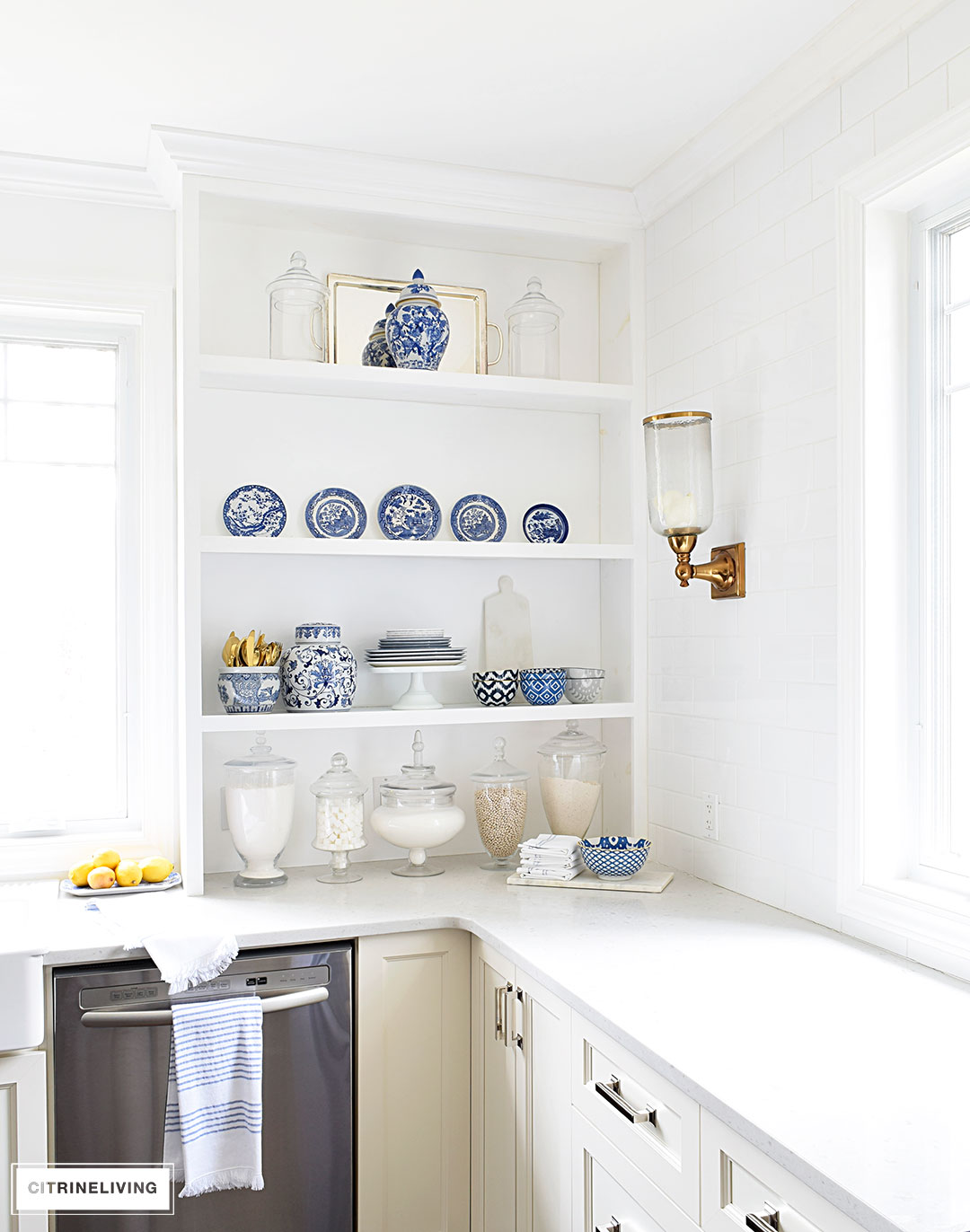 A gorgeous display of blue and white accessories and dishware on open shelving is sophisticated and elegant. 