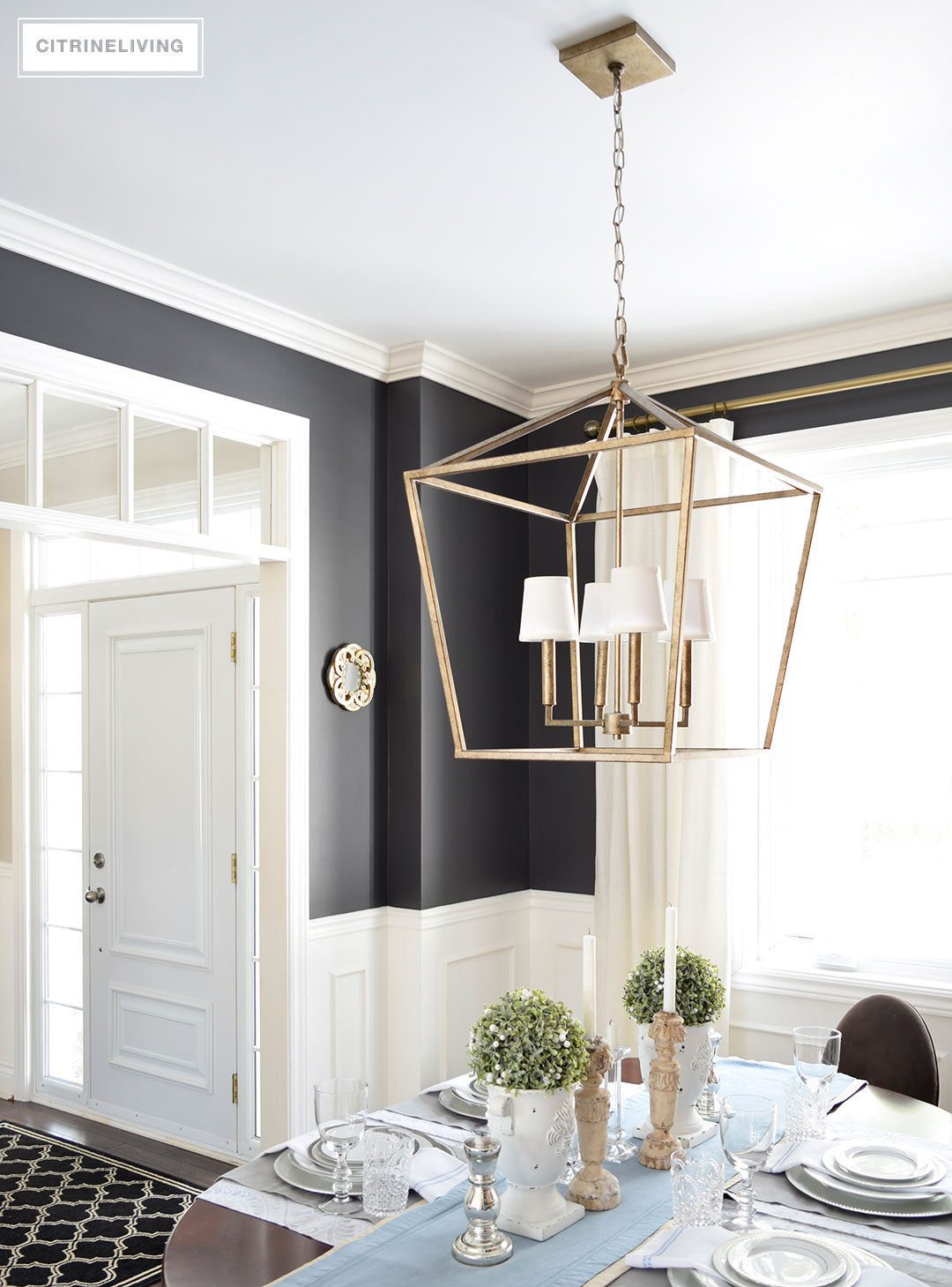 A lantern style chandelier gets an elegant update with the addition of white chandelier shades.