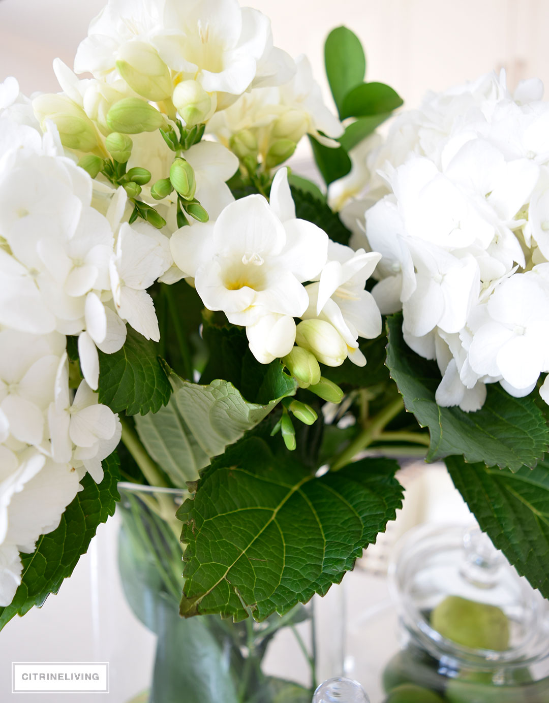 Beautiful hydrangeas and freesias create a beautiful kitchen table centerpiece for Spring and Summer.