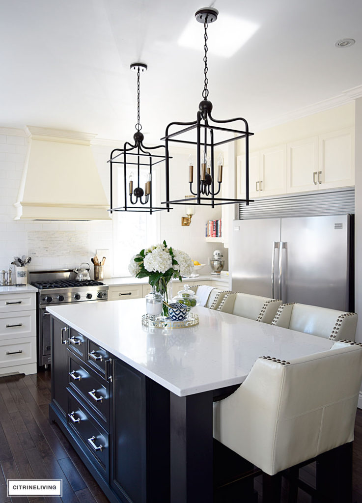 Bright and airy kitchen with lantern style pendant lighting over the island. 