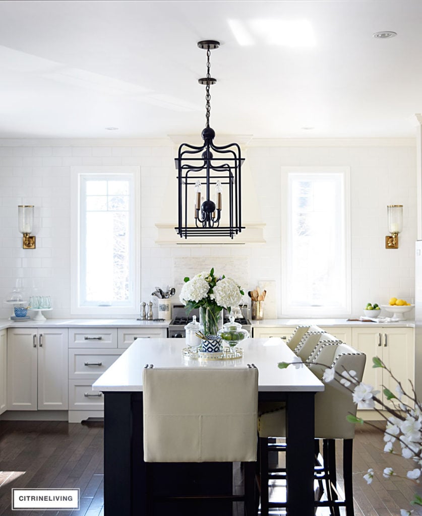 Bright and airy kitchen with lantern style pendant lighting over the island. 