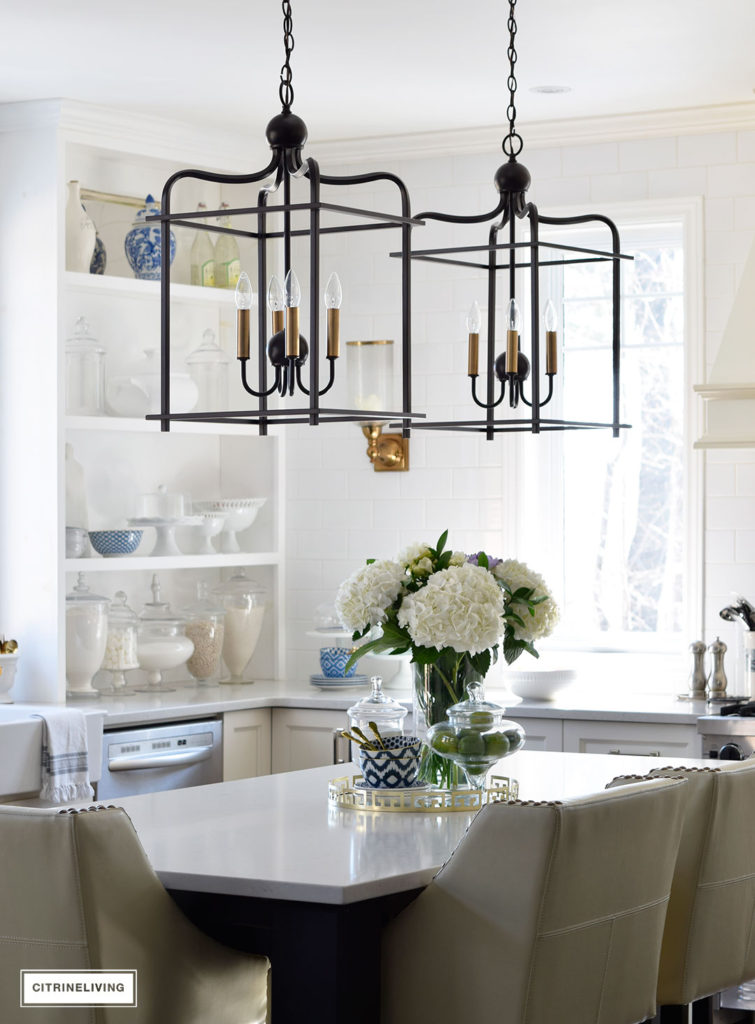 Bright and airy kitchen with lantern style pendant lighting over the island. 