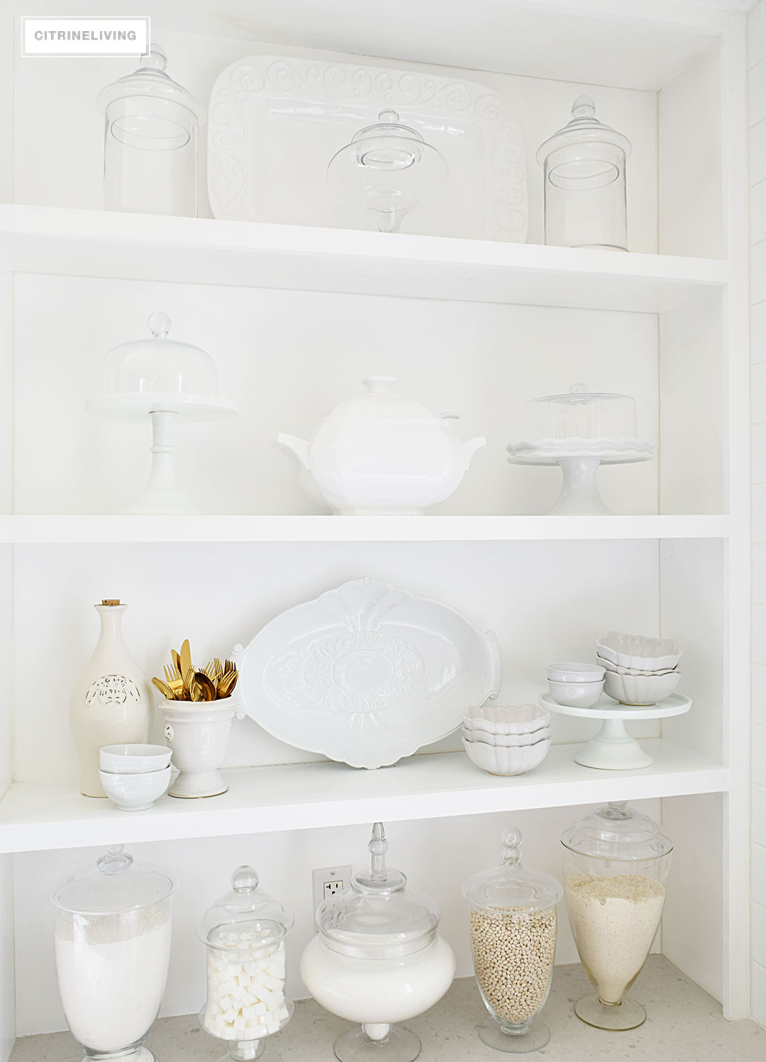 Bring vintage flair to your open kitchen shelving with a mix of white and cream serving pieces and dishware for a fresh, layered look.