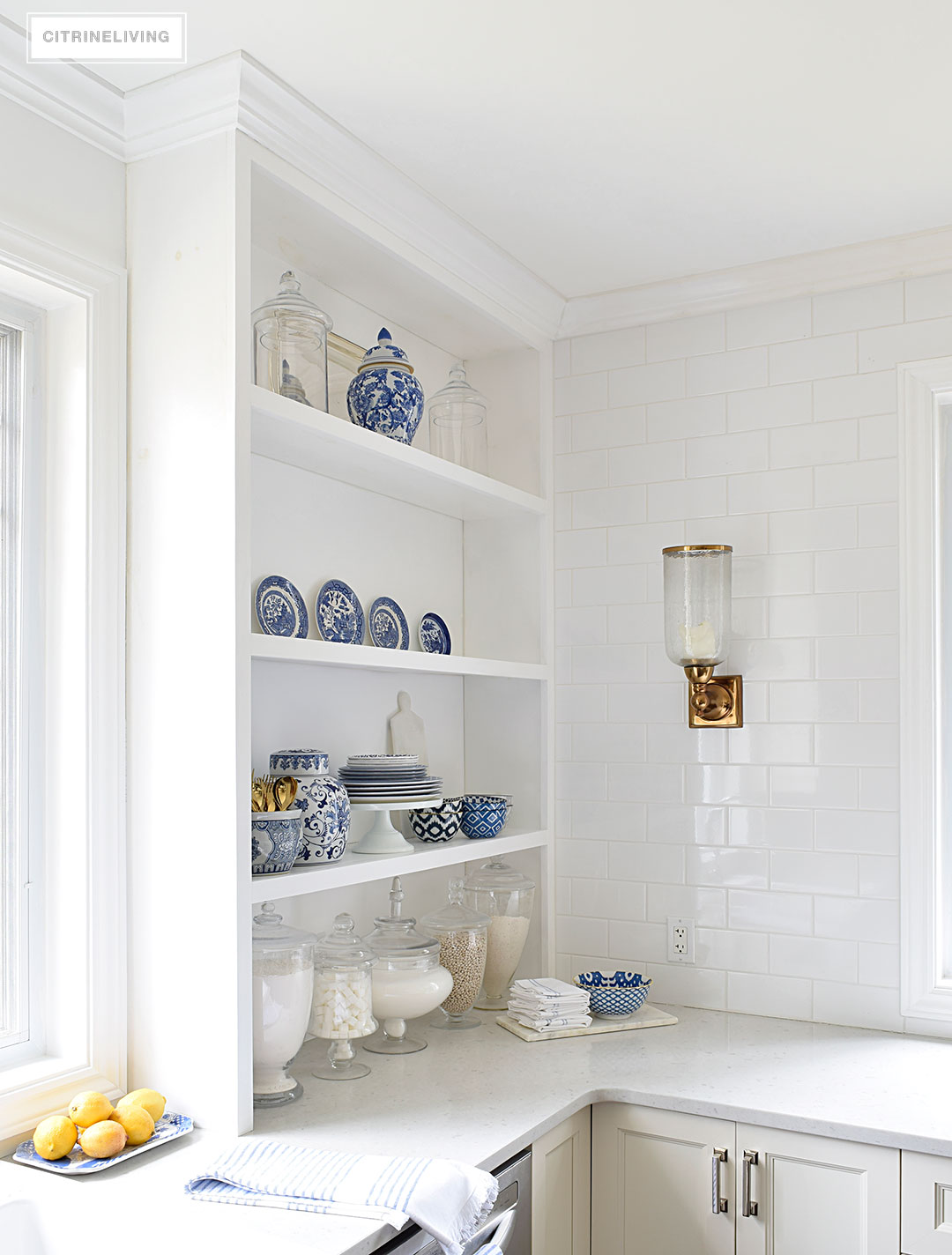 A white kitchen with open shelving is the perfect home for gorgeous blue and white accessories and dishes on display.