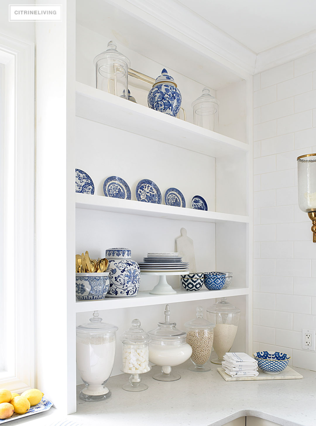 A white kitchen with open shelving is the perfect home for gorgeous blue and white accessories and dishes on display.