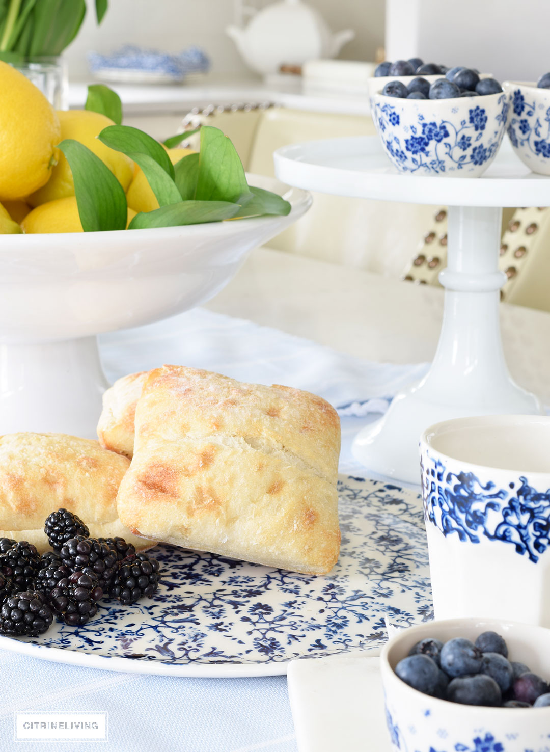 Create a welcoming tablescape of blue and white accented with fresh lemons.