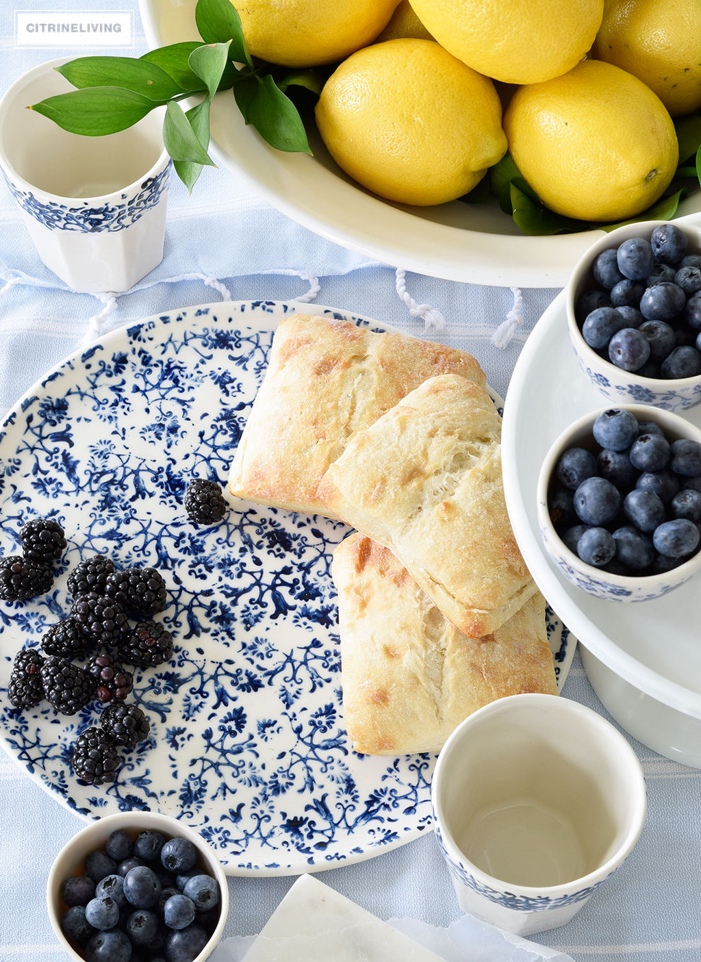 Create a welcoming tablescape of blue and white accented with fresh lemons.