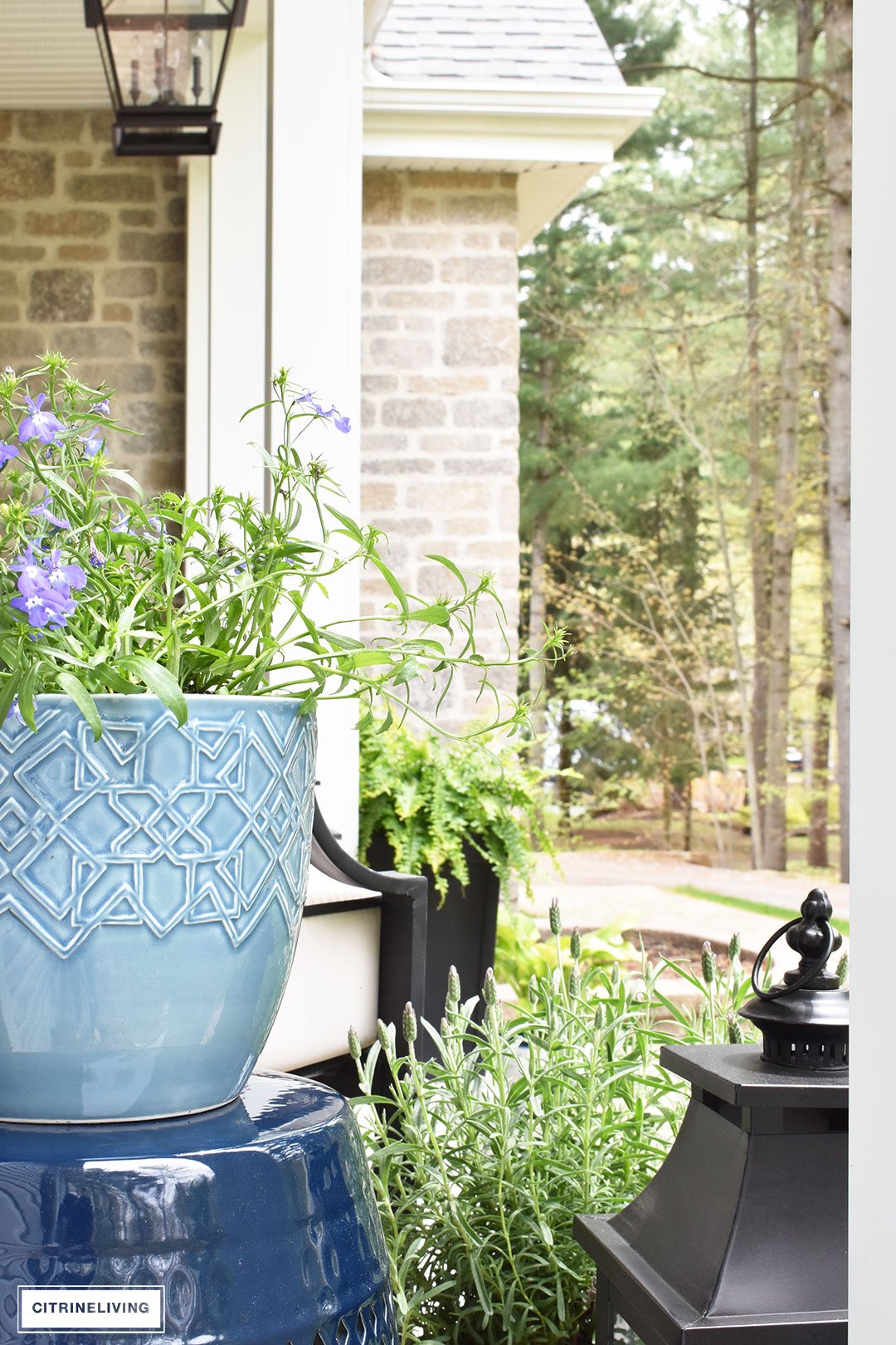 Create a chic Spring porch decorated with blue and white accents: garden stools, potted plants with some boho-chic and nautical pieces thrown into the mix!