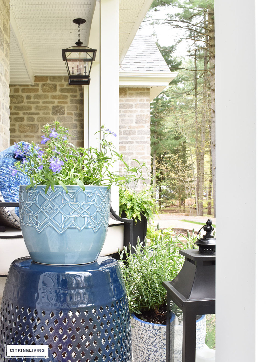 Create a chic Spring porch decorated with blue and white accents: garden stools, potted plants with some boho-chic and nautical pieces thrown into the mix!