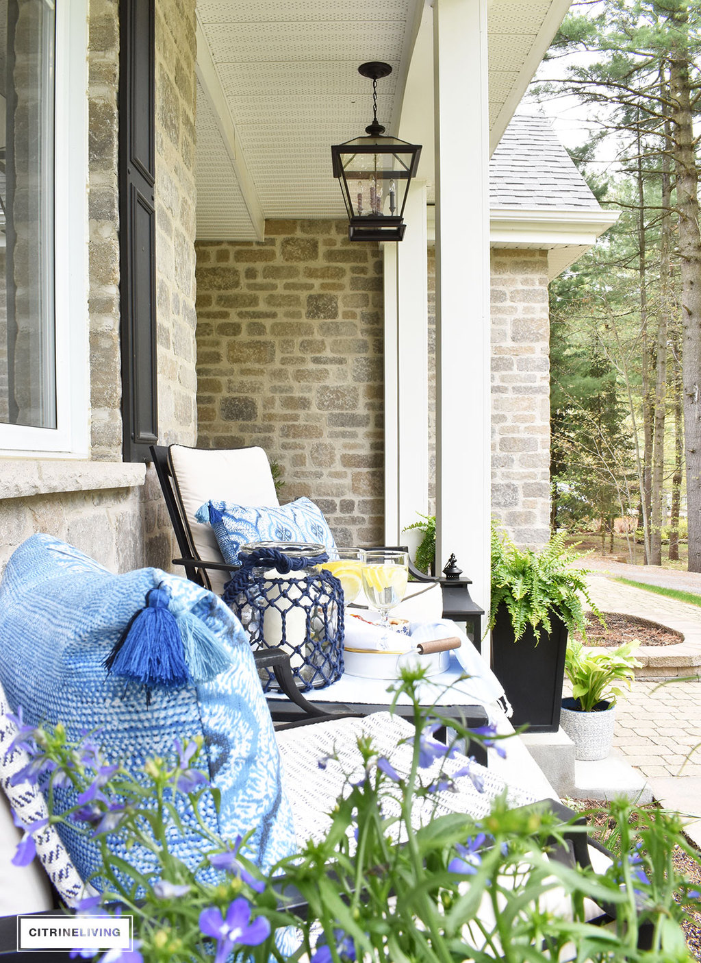 Create a chic Spring porch decorated with blue and white accents: garden stools, potted plants with some boho-chic and nautical pieces thrown into the mix!