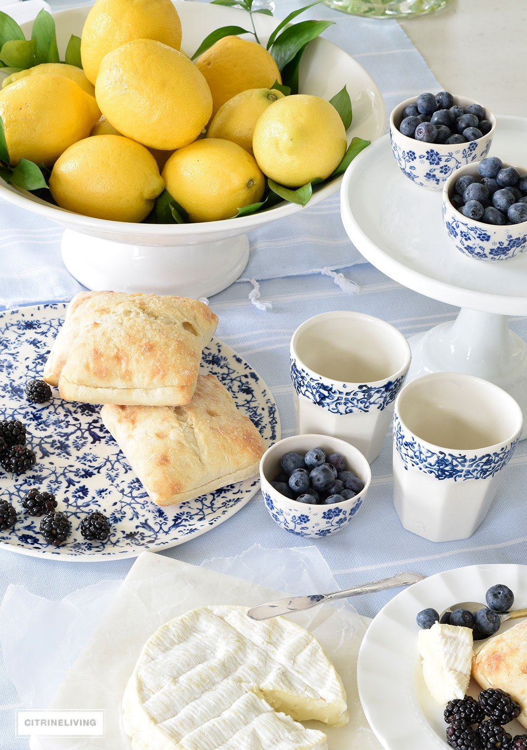 Create a welcoming tablescape of blue and white accented with fresh lemons.