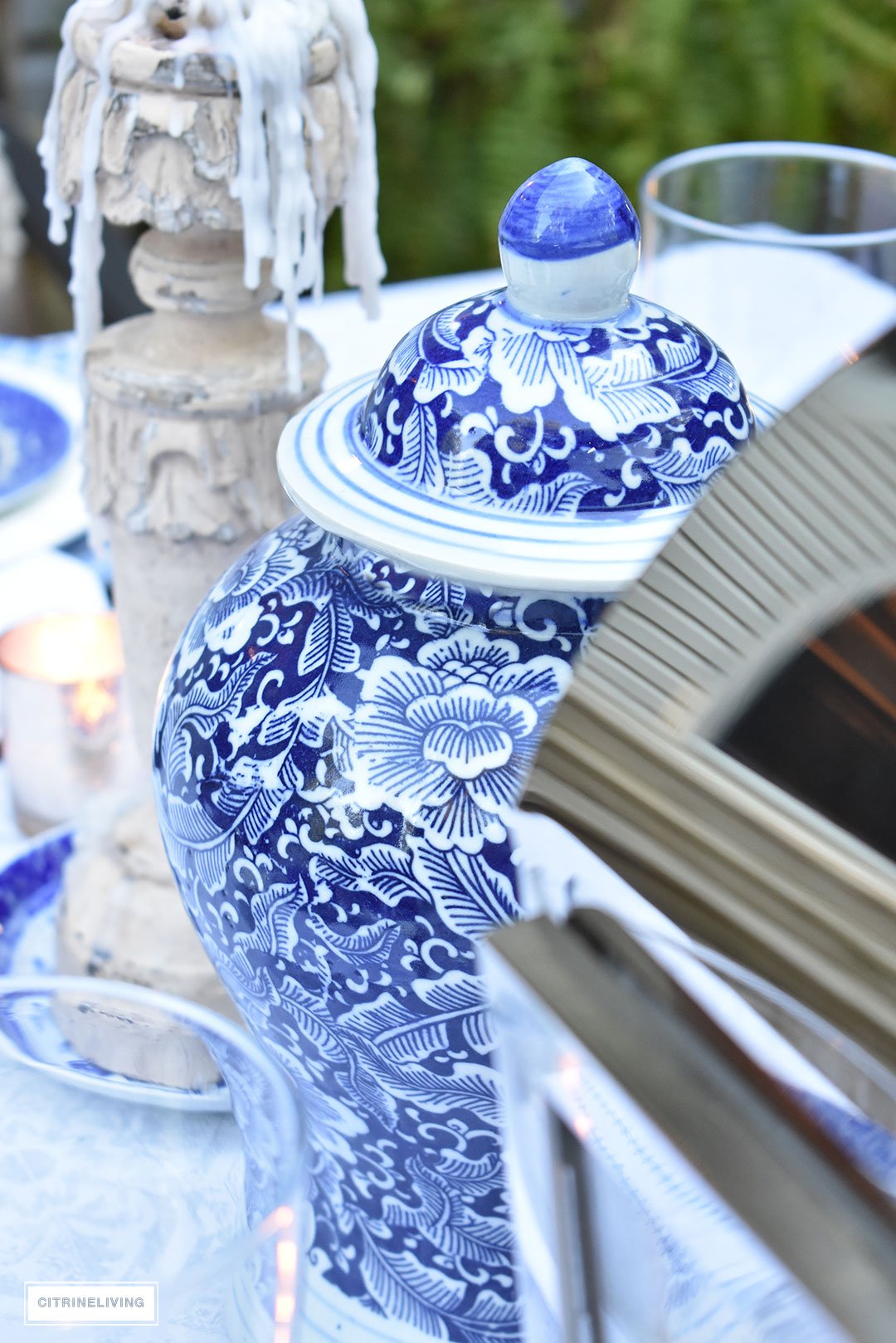 An outdoor tablescape with blue and white ginger jars and a mix of blue and white patterned dishes brings a casual yet elegant look to your outdoor space.