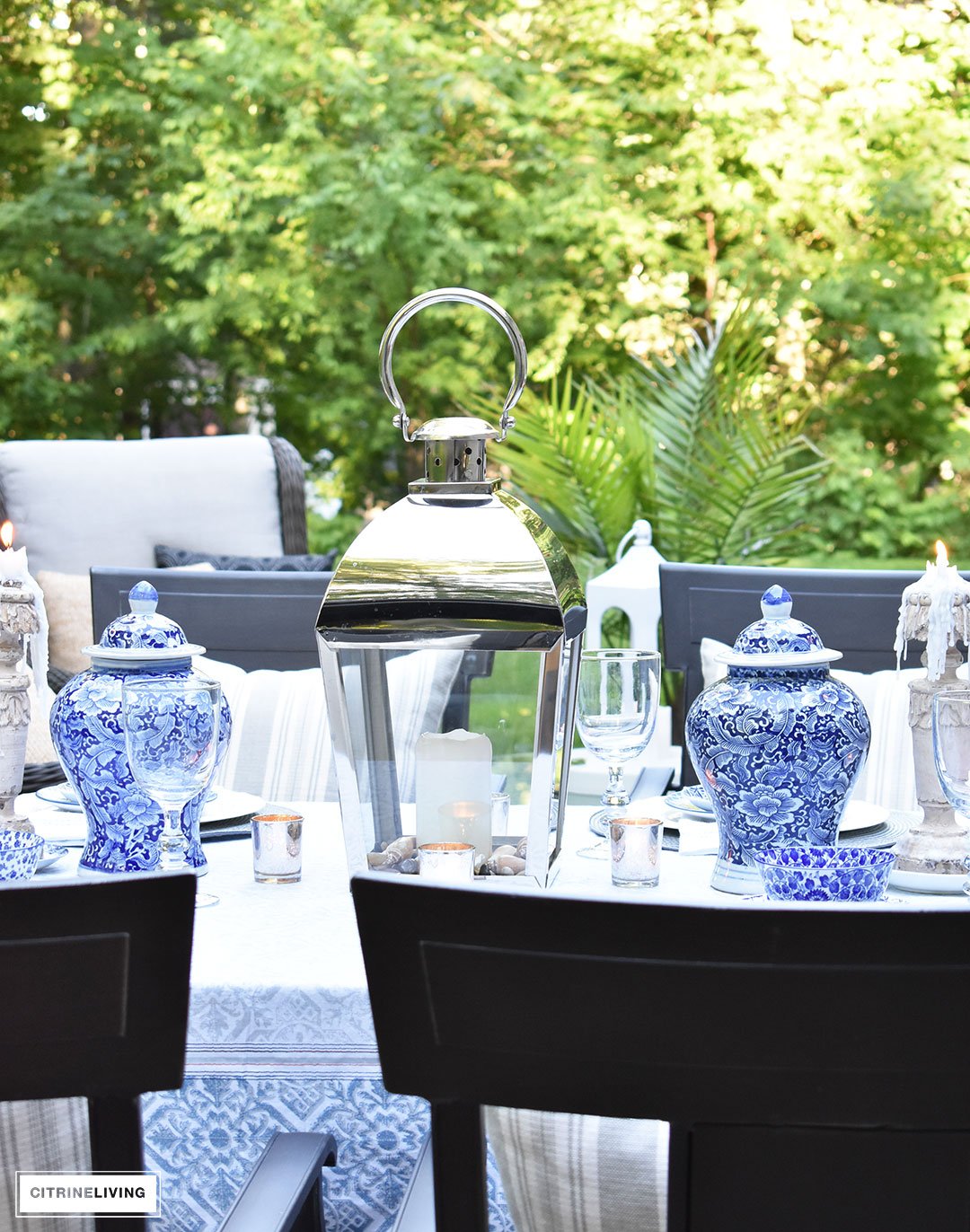 An outdoor tablescape with blue and white ginger jars and a mix of blue and white patterned dishes brings a casual yet elegant look to your outdoor space.