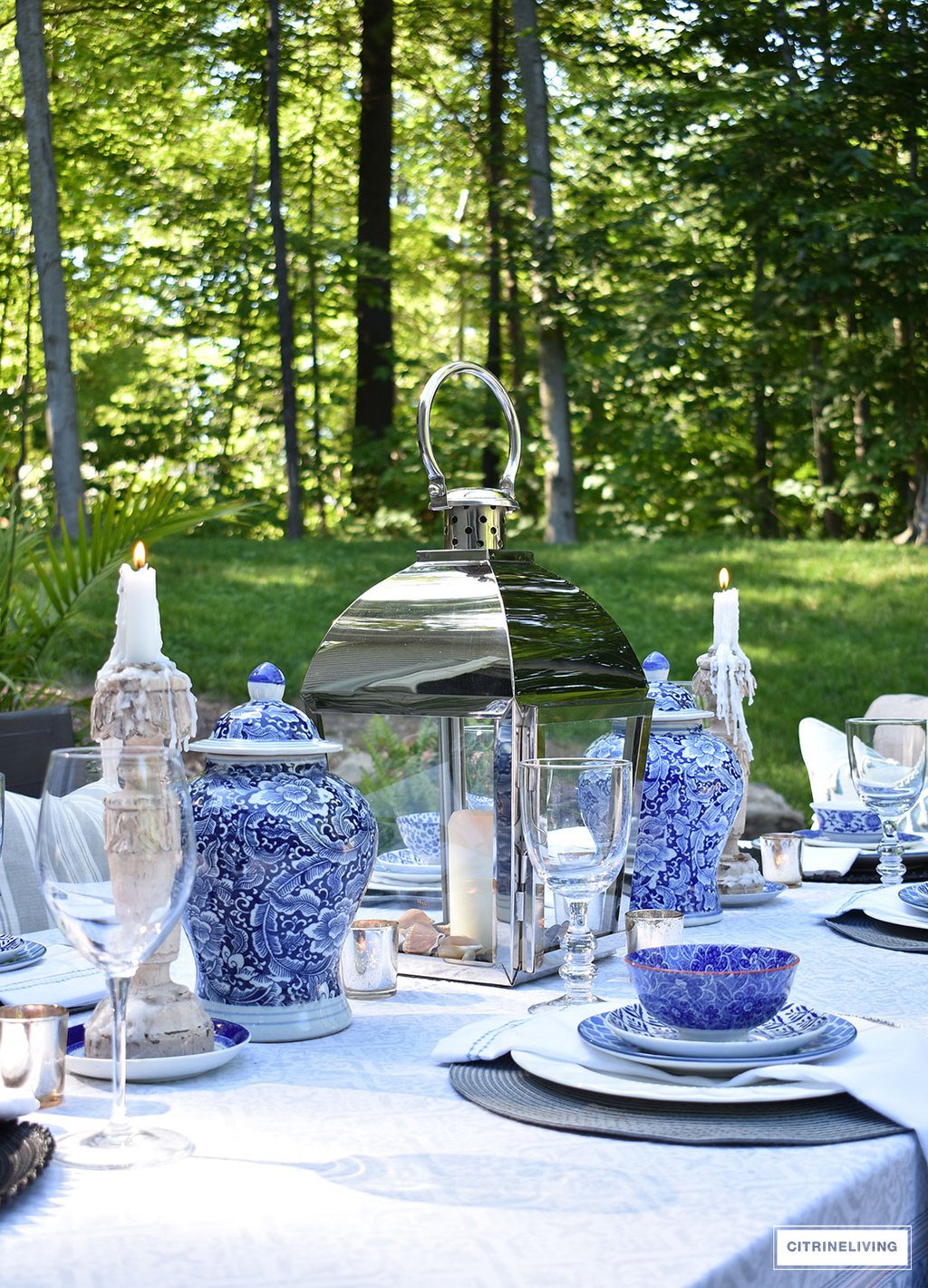 An outdoor tablescape with blue and white ginger jars and a mix of blue and white patterned dishes brings a casual yet elegant look to your outdoor space.