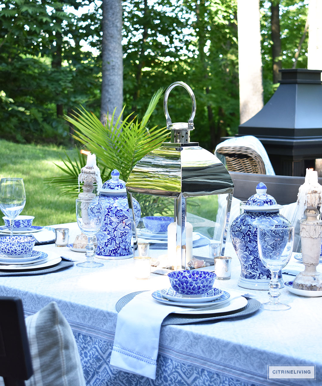 An outdoor tablescape with blue and white ginger jars and a mix of blue and white patterned dishes brings a casual yet elegant look to your outdoor space.