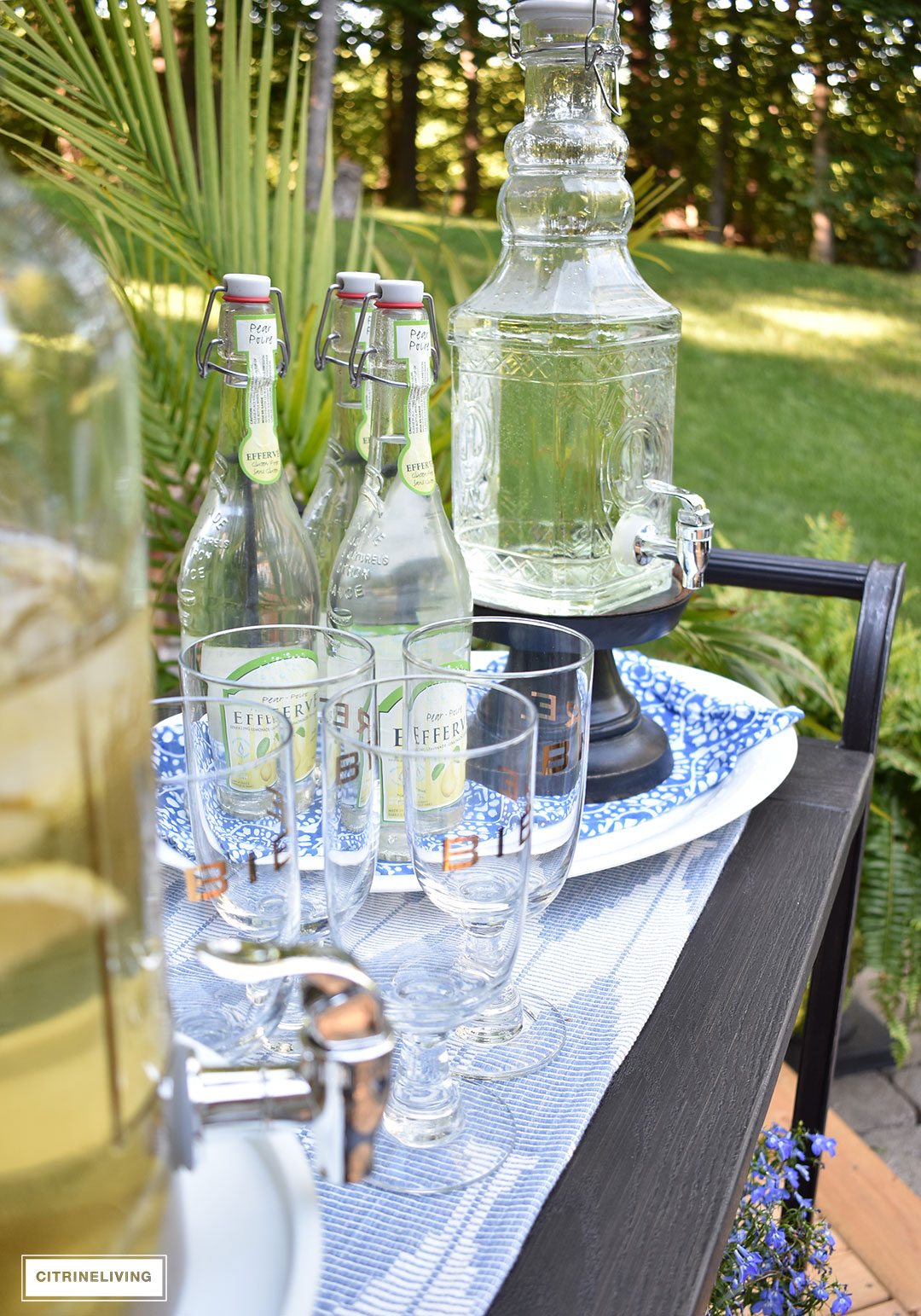 Use an outdoor bar cart layered with vintage inspired glassware and drink dispensers for your Summer entertaining.