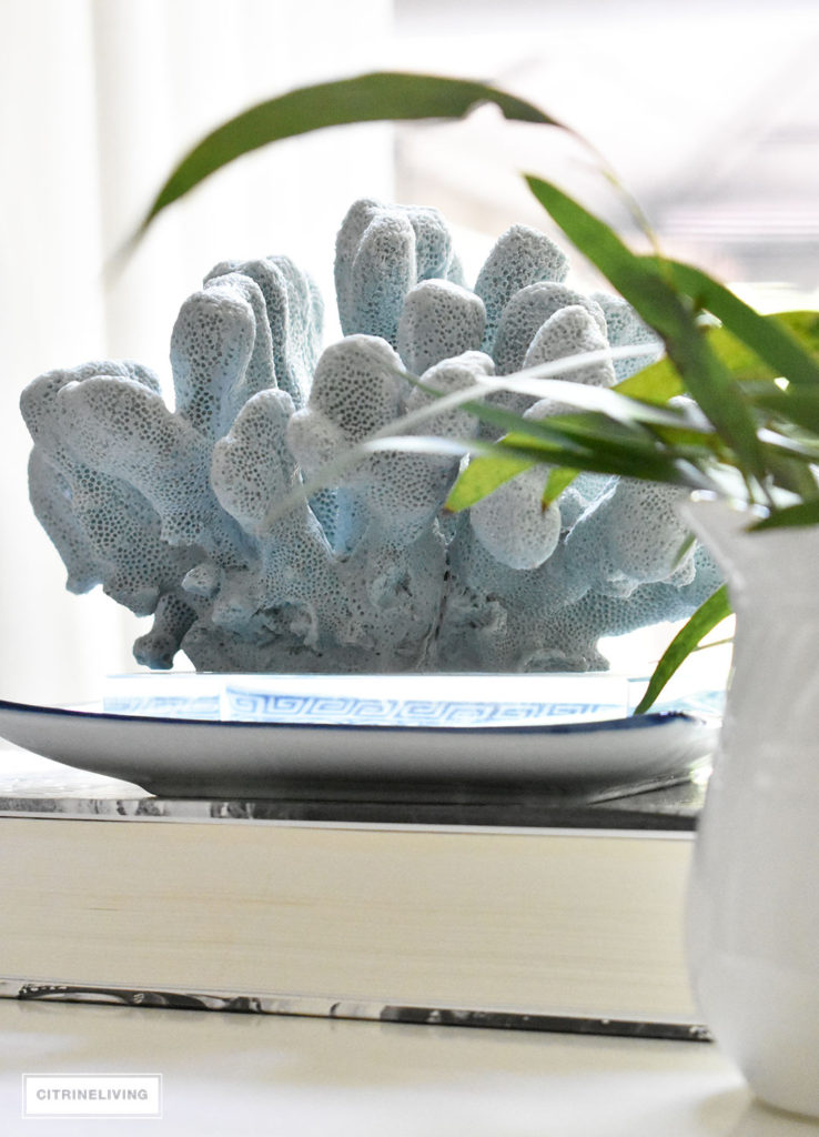 Light blue coral layered with blue and white and fresh greenery.