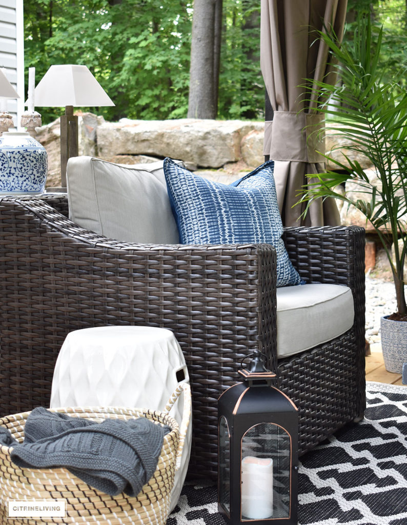 Create a comfortable and inviting outdoor setting with resin wicker club chairs and layered accessories. Blue and white touches are always classic and elegant for Summer decorating outdoors!