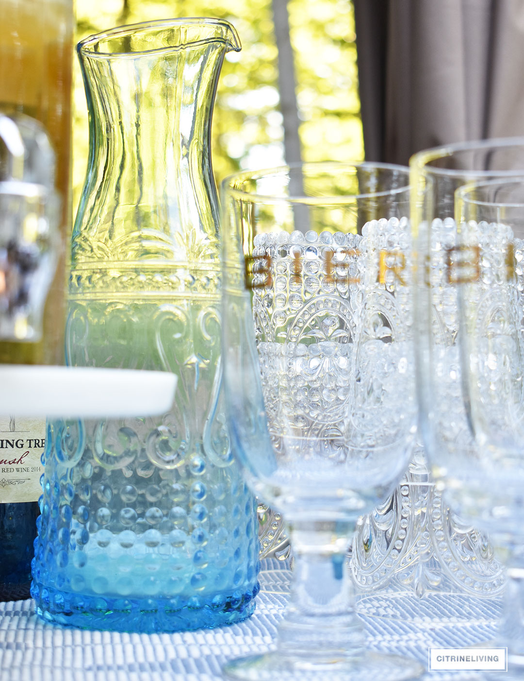 Use an outdoor bar cart layered with vintage inspired glassware and drink dispensers for your Summer entertaining.