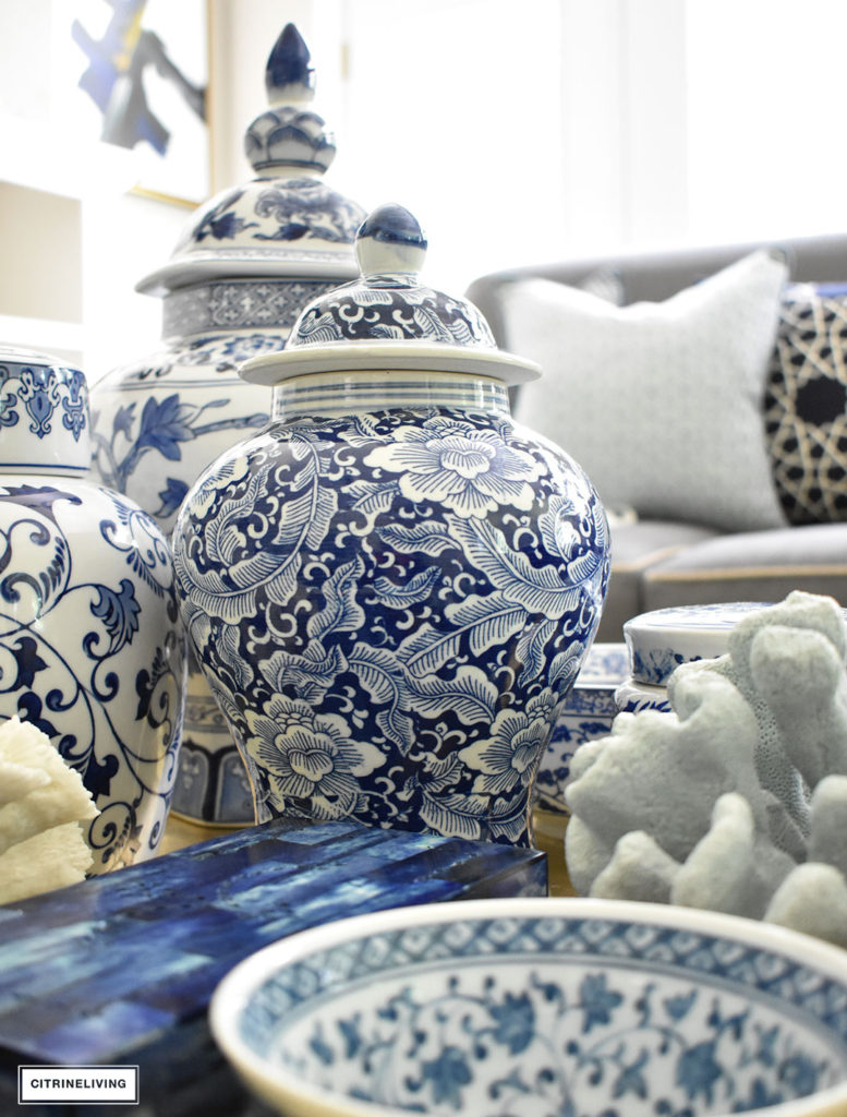 Style your coffee table with a clustered grouping of blue and white ginger jars and accessories. Use the same idea for any monochromatic display.
