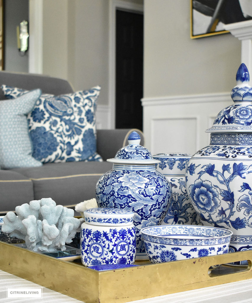 Style your coffee table with a clustered grouping of blue and white ginger jars and accessories. Use the same idea for any monochromatic display.