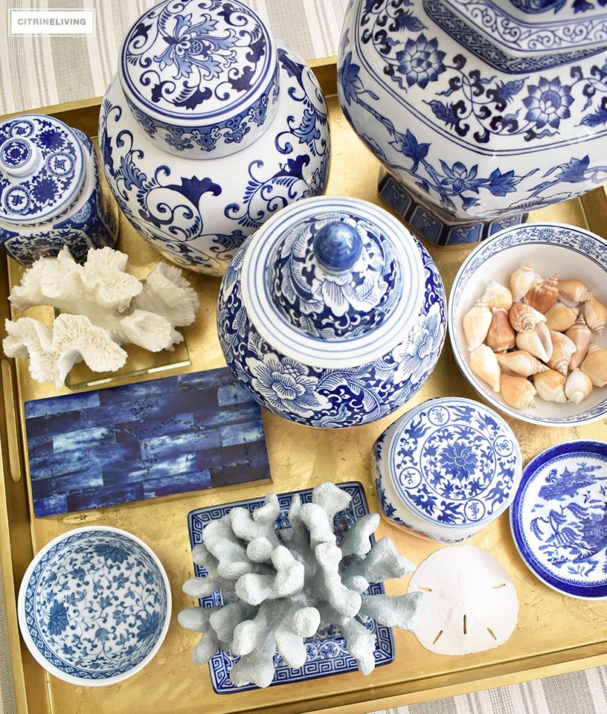 Style your coffee table with a clustered grouping of blue and white ginger jars and accessories. Use the same idea for any monochromatic display.