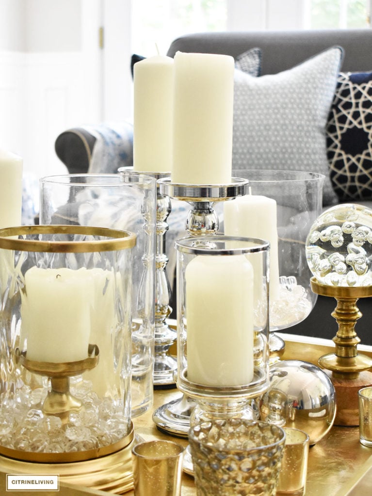 Make a visual statement with a clustered grouping of metal and glass candleholders in varying heights on your coffee table.