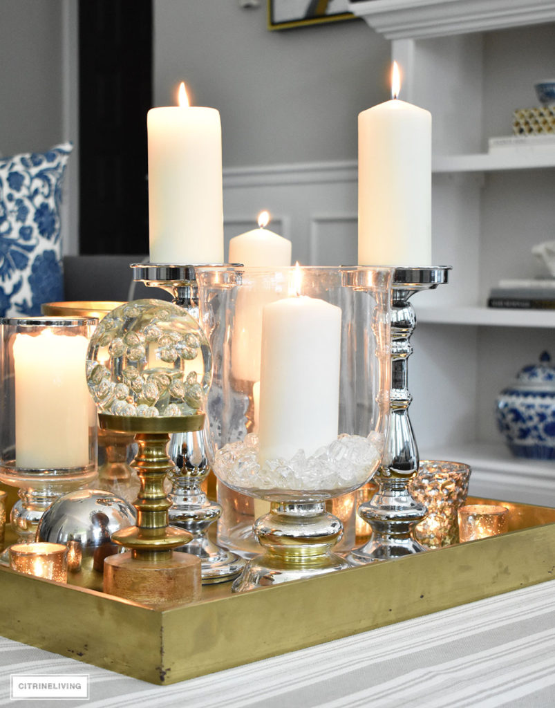 Make a visual statement with a clustered grouping of metal and glass candleholders in varying heights on your coffee table.