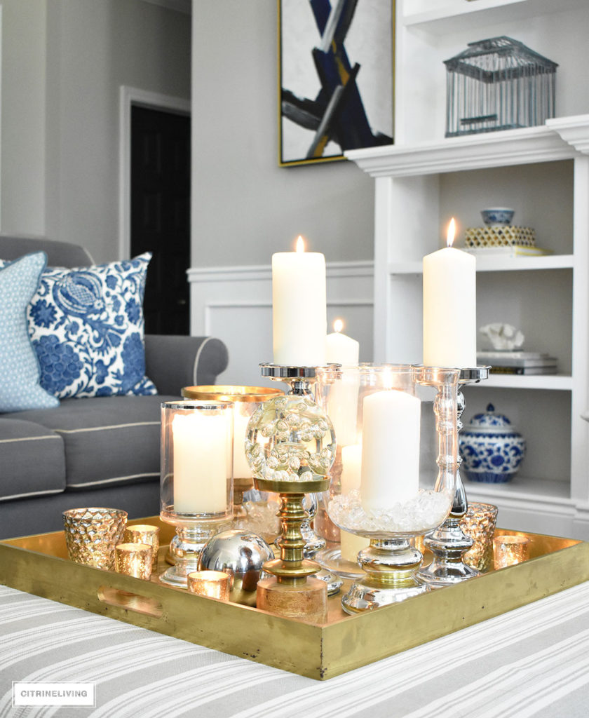 Make a visual statement with a clustered grouping of metal and glass candleholders in varying heights on your coffee table.