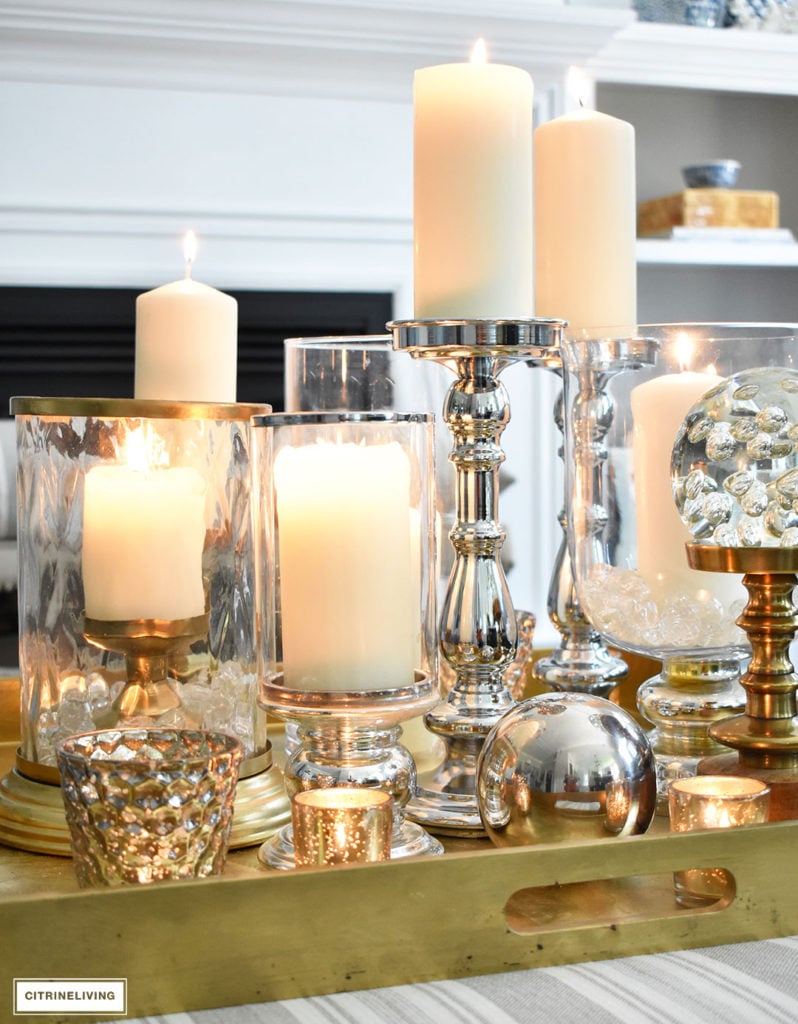 Make a visual statement with a clustered grouping of metal and glass candleholders in varying heights on your coffee table.