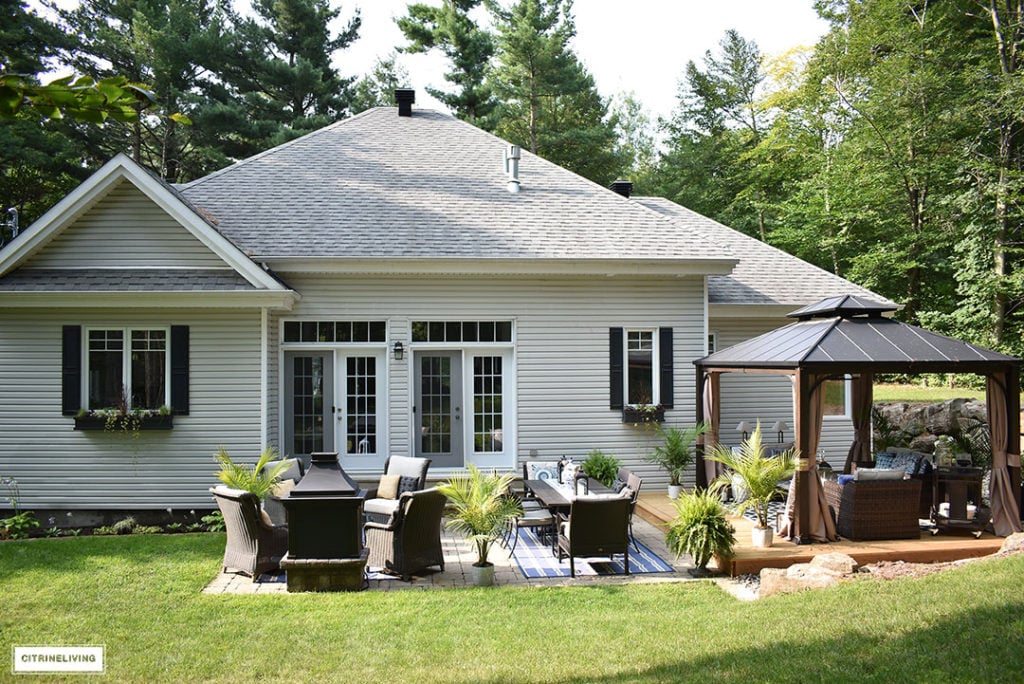 Backyard patio and gazebo with a view of the back of the home.