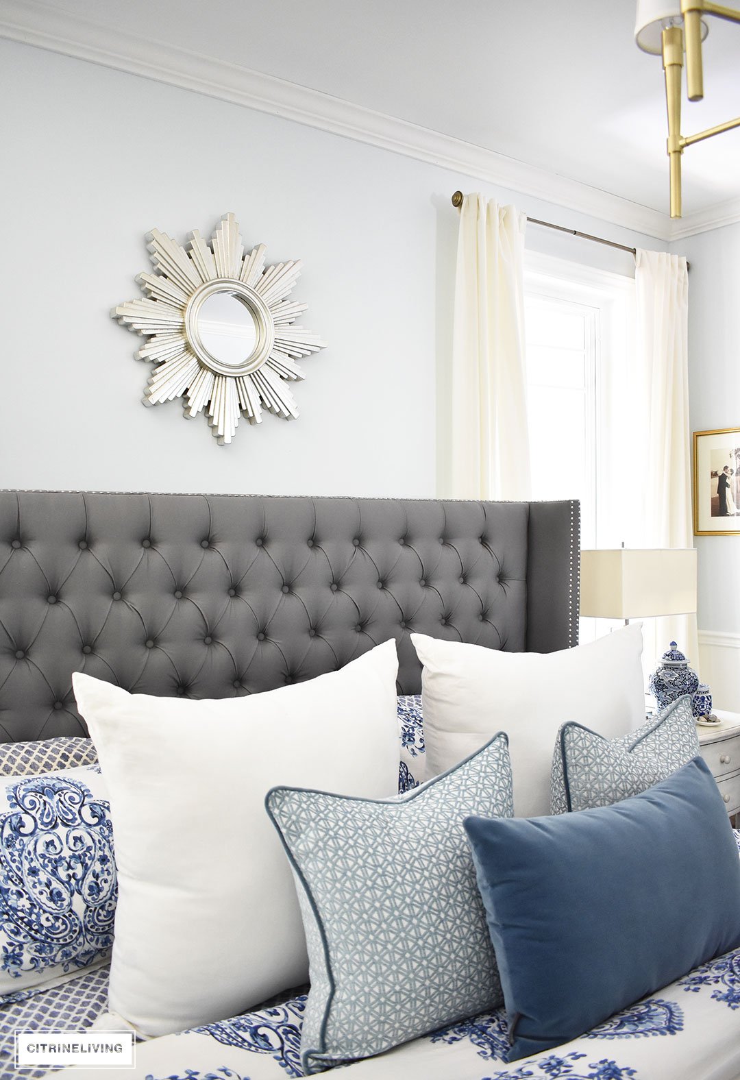 A sunburst mirror is a chic and classic addition to any space! This beautiful blue and white bedroom accented with a mix of cool and warm metals is elegant, warm and inviting. A metallic sunburst mirror as the perfect finishing touch.