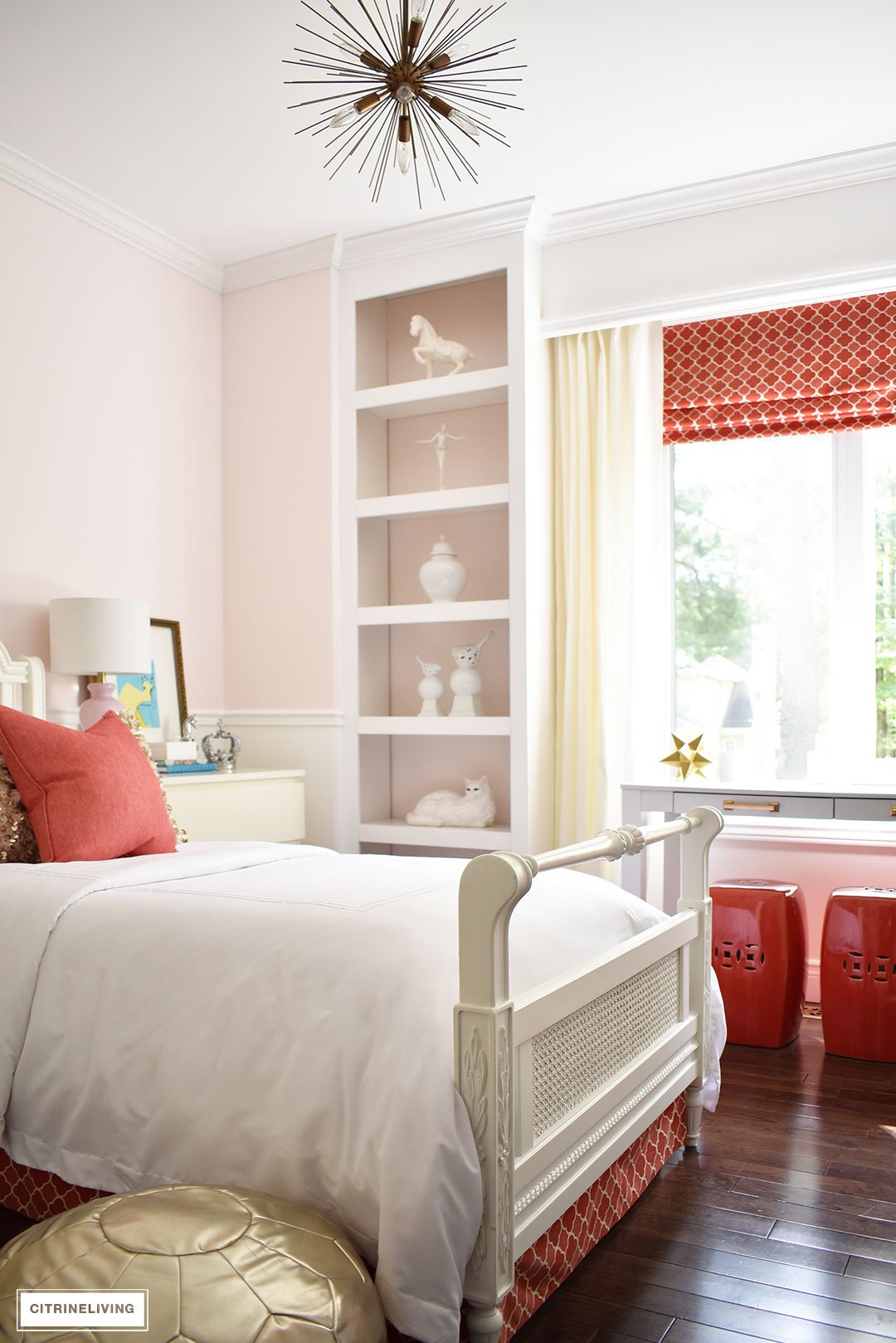 A chic, modern girl's bedroom featuring blush pink walls, coral and brass accessories and brass lighting, is a fun and sophisticated look!