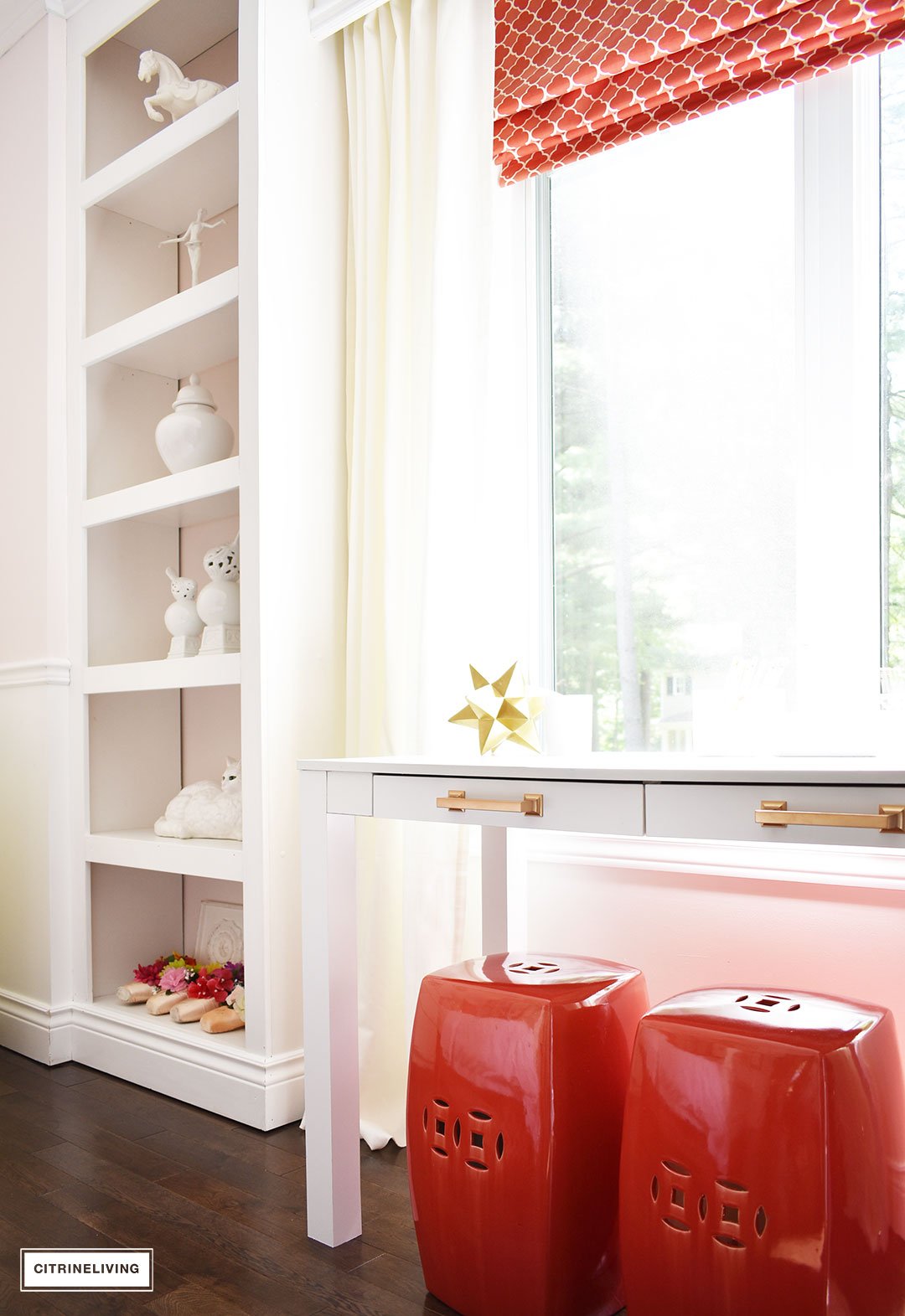 A chic, modern girl's bedroom featuring blush pink walls, coral and brass accessories and brass lighting, is a fun and sophisticated look!