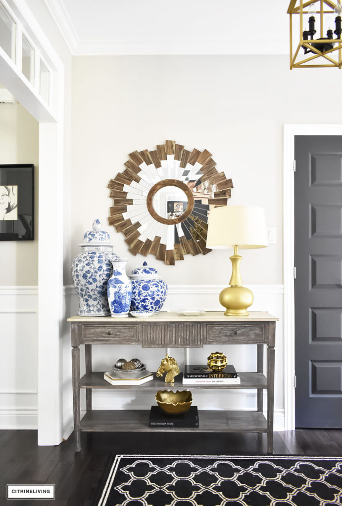 Fall home tour with elegant entryway featuring layers of gold accessories and blue and white ginger jars.